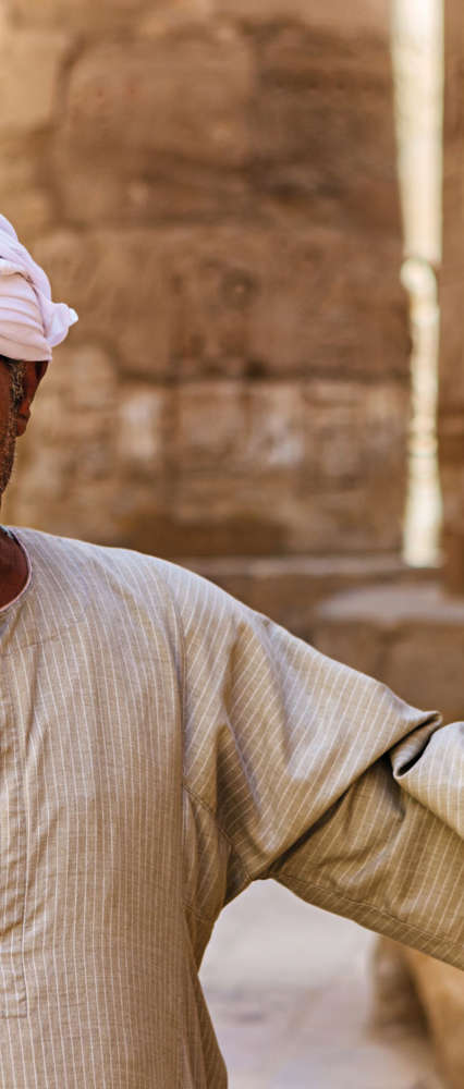 Man leaning on Karnak Temple, Egypt