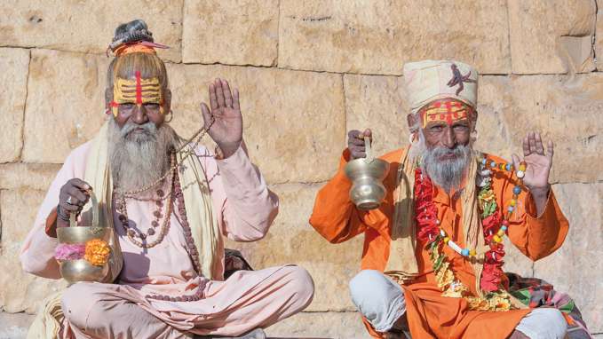 Holy men sitting on steps, India