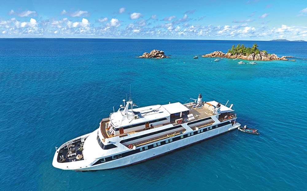 MY Pegasus Vessel Seychelles, Exterior at sea with Island